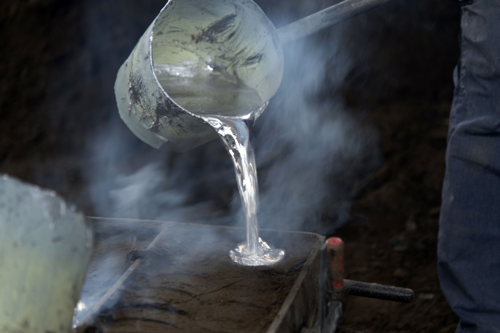 pouring metal out of vat
