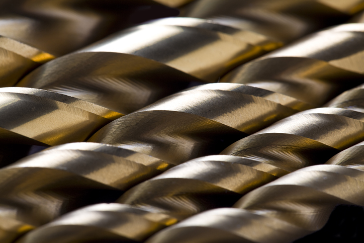 close up image of metal drill bits lined up beside each other, silver in color